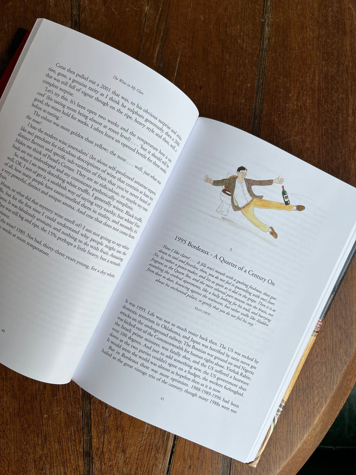 Open book on a wooden surface with a character illustration