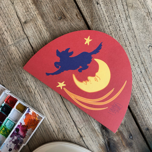 Red artist sketchbook with a dog leaping over a moon design. Ideal for sketching drawing painting, multimedia. Perfect for creative projects and neurodiverse profiles.